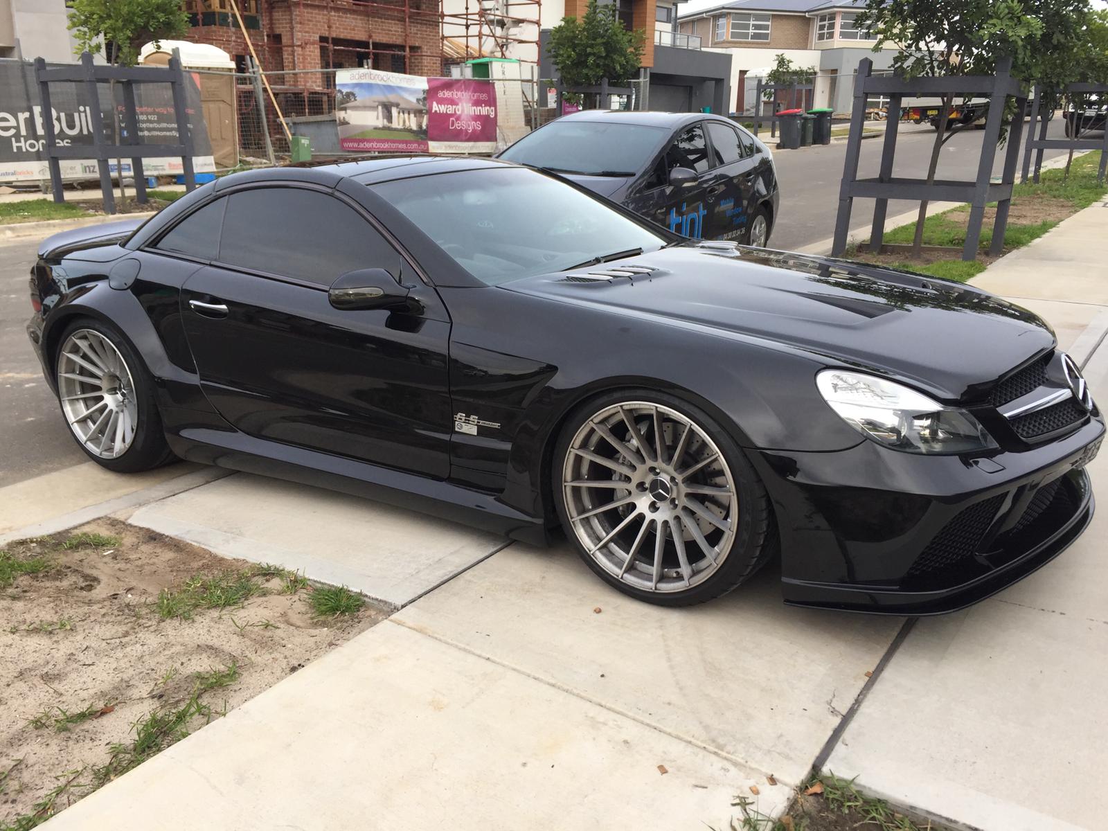 Ceramic tint a black Mercedes sports side view
