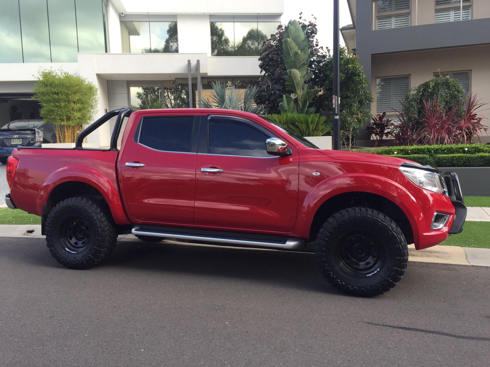 Car tint a red Nissan Navara side view