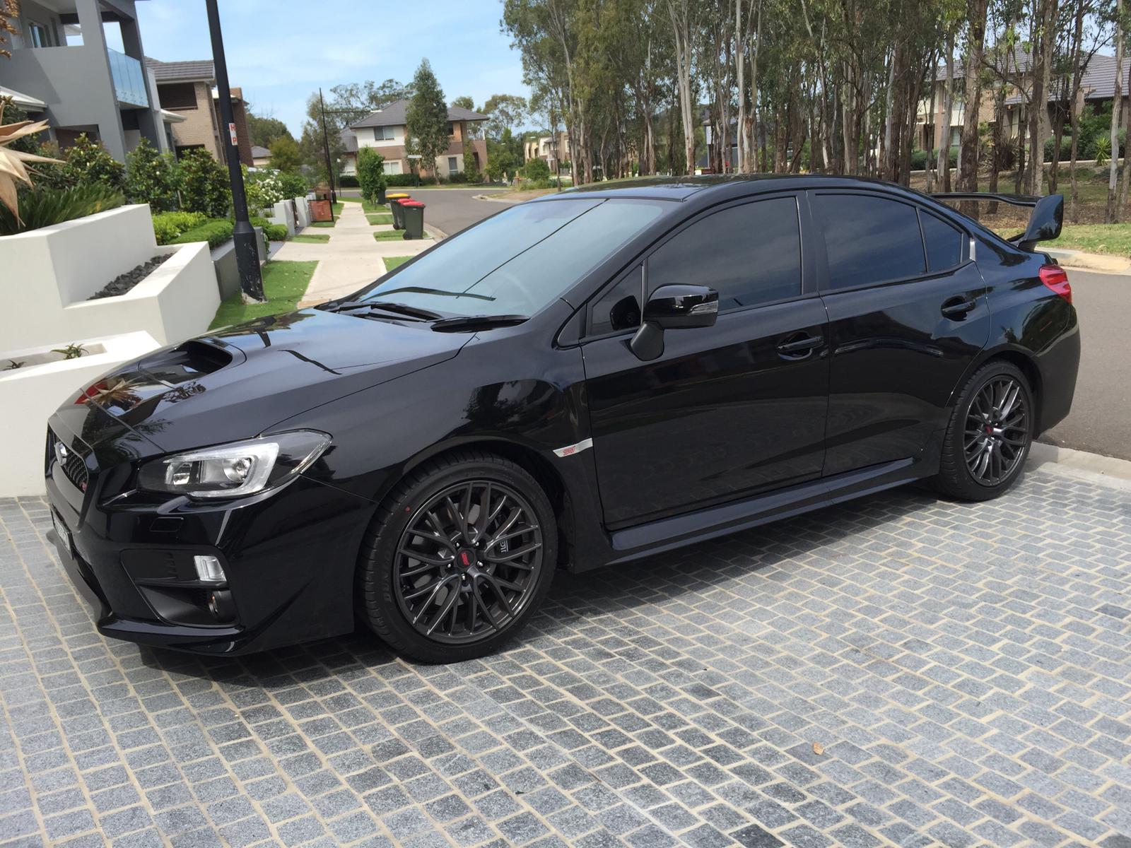 Car tint a black Subaru WRX station wagon