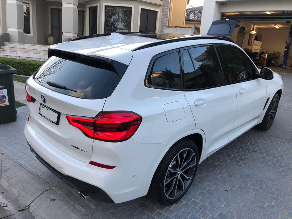 Car tint a white BMW 4x4 rear view