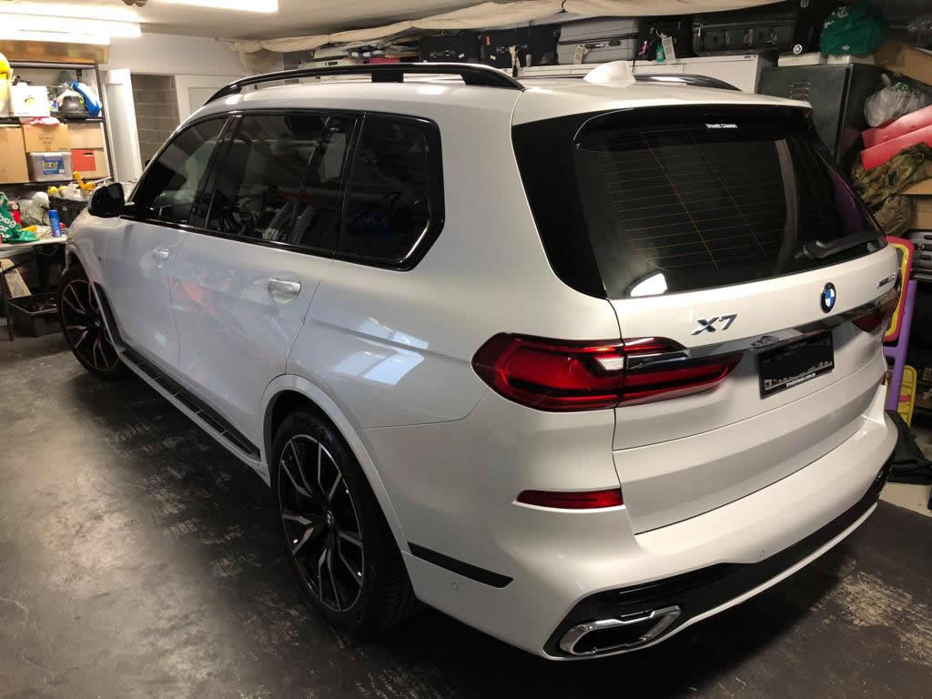 Car tint a white BMW 4x4 rear side view