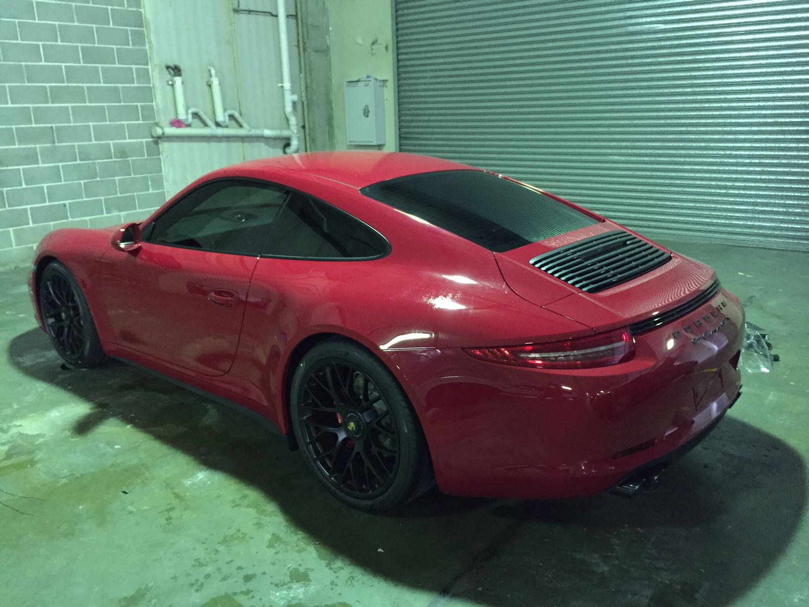 Car tint a red Porsche rear view