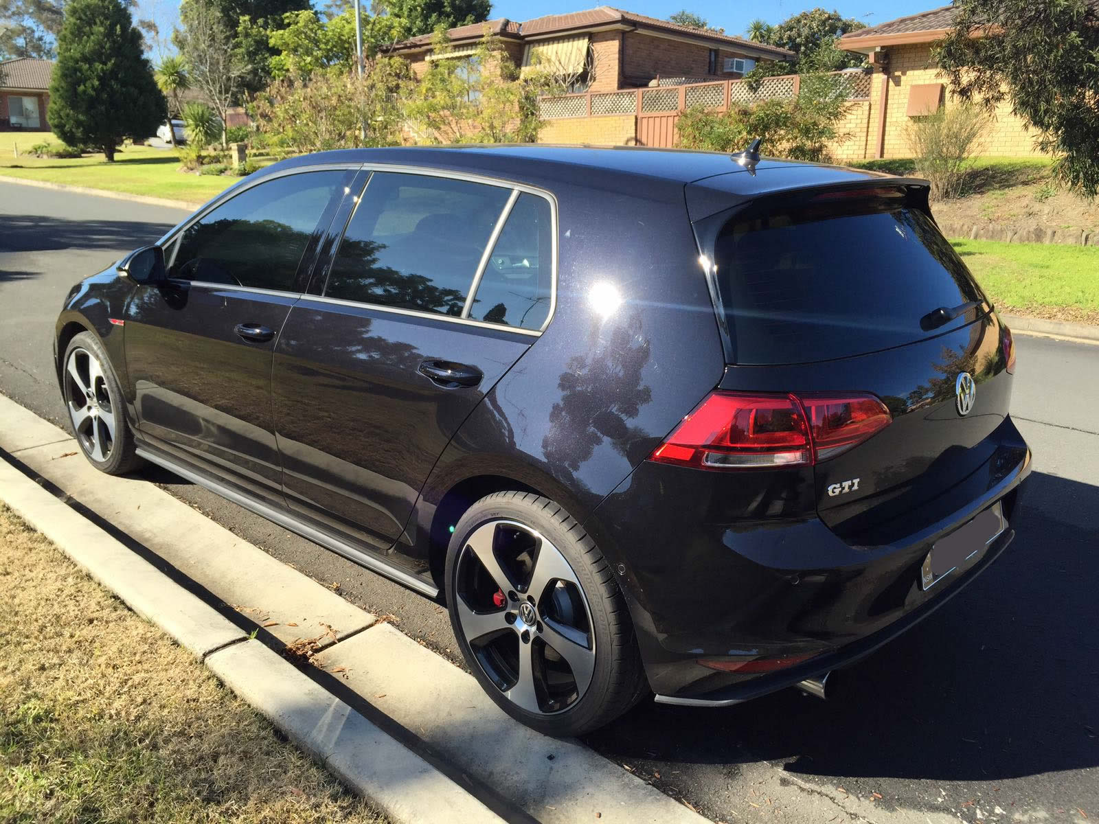 Car tint a black VW Golf rear side view