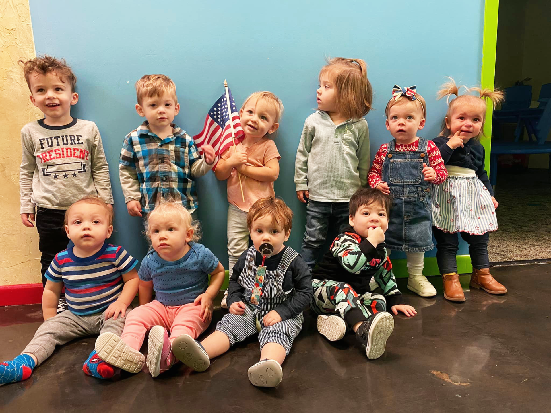 Graceway Children Academy - Toddlers Posing with an American Flag