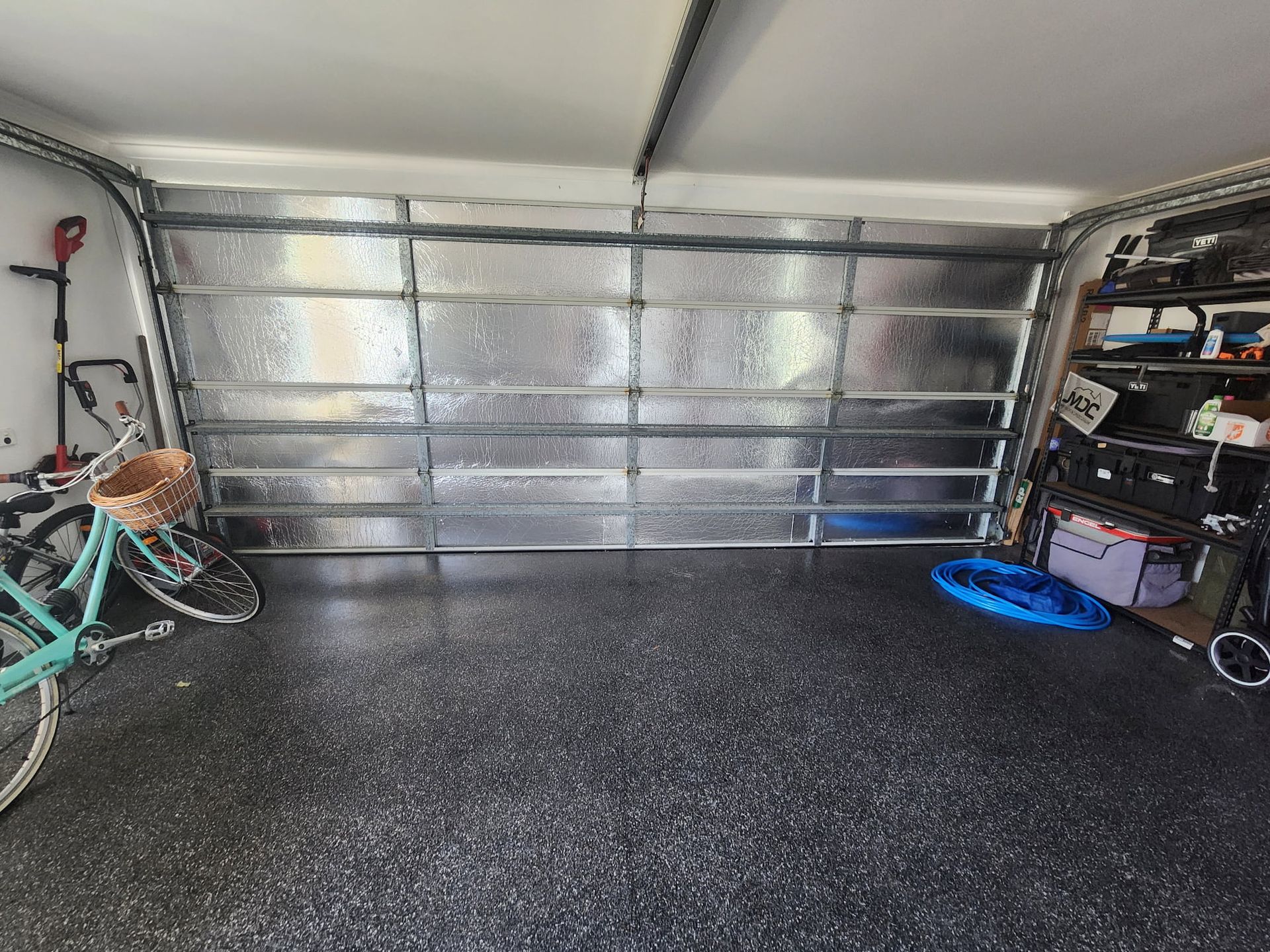 An Empty Garage With White Walls and a Concrete Floor — Vent Wise in Twin Waters, QLD