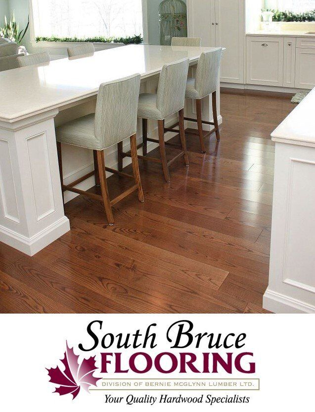 A kitchen with a wooden floor and a sign that says south bruce flooring