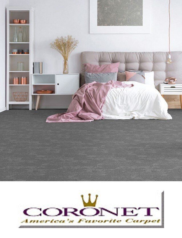 A bedroom with a bed and a coronet carpet