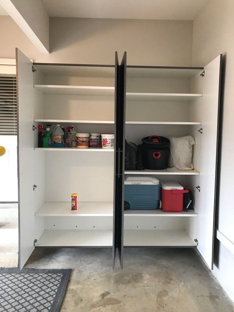 A closet with a lot of shelves and a cooler inside of it.