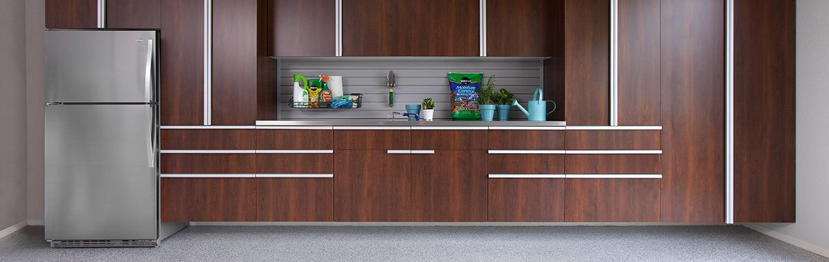 A kitchen with wooden cabinets and a stainless steel refrigerator.