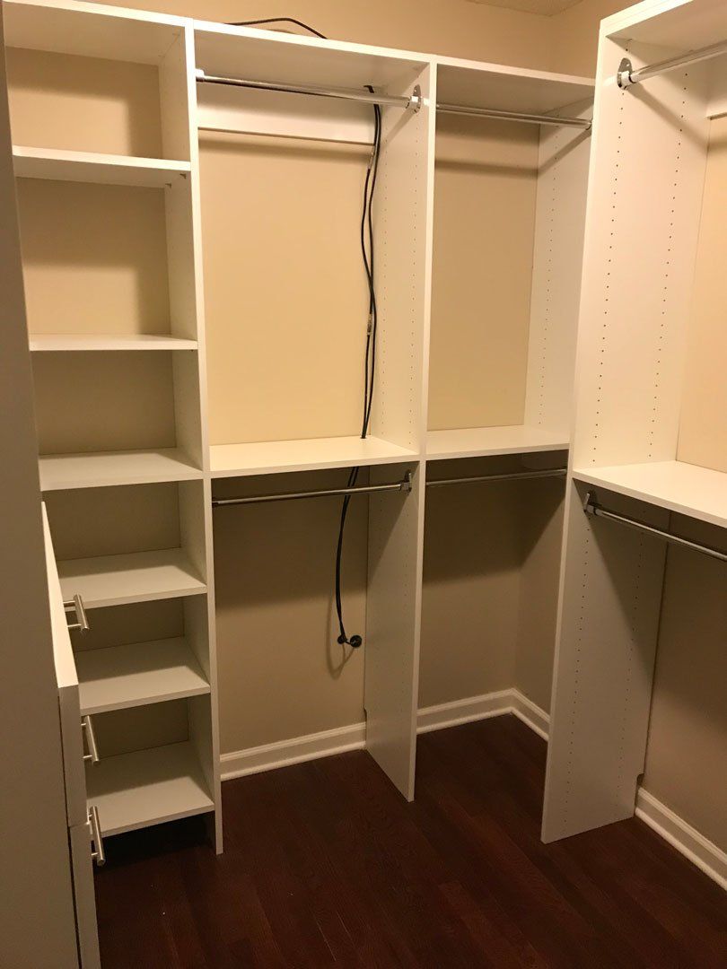 A walk in closet with lots of shelves and hangers