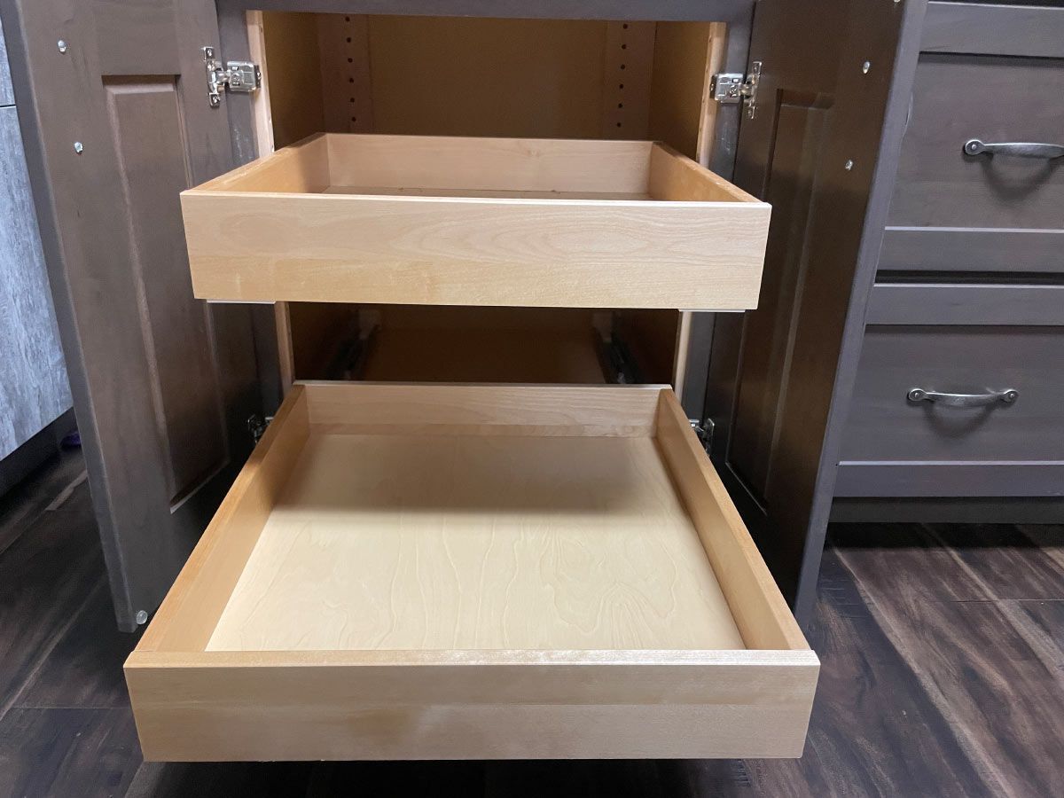 A wooden drawer is pulled out of a cabinet