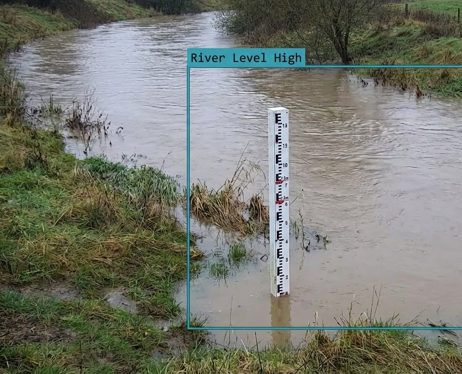 A flooded river with a sign that says river abnormally high
