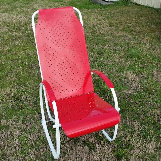 A Red Rocking Chair is Sitting in the Grass
