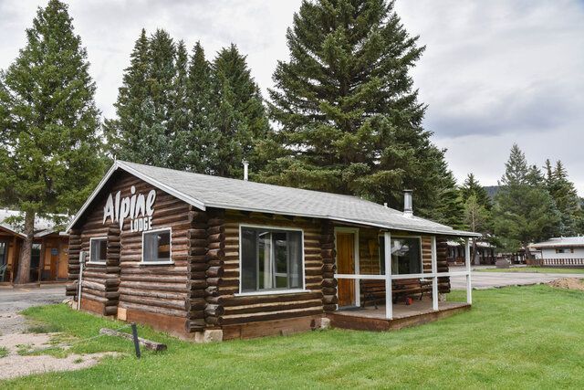 Rustic log cabin with the word