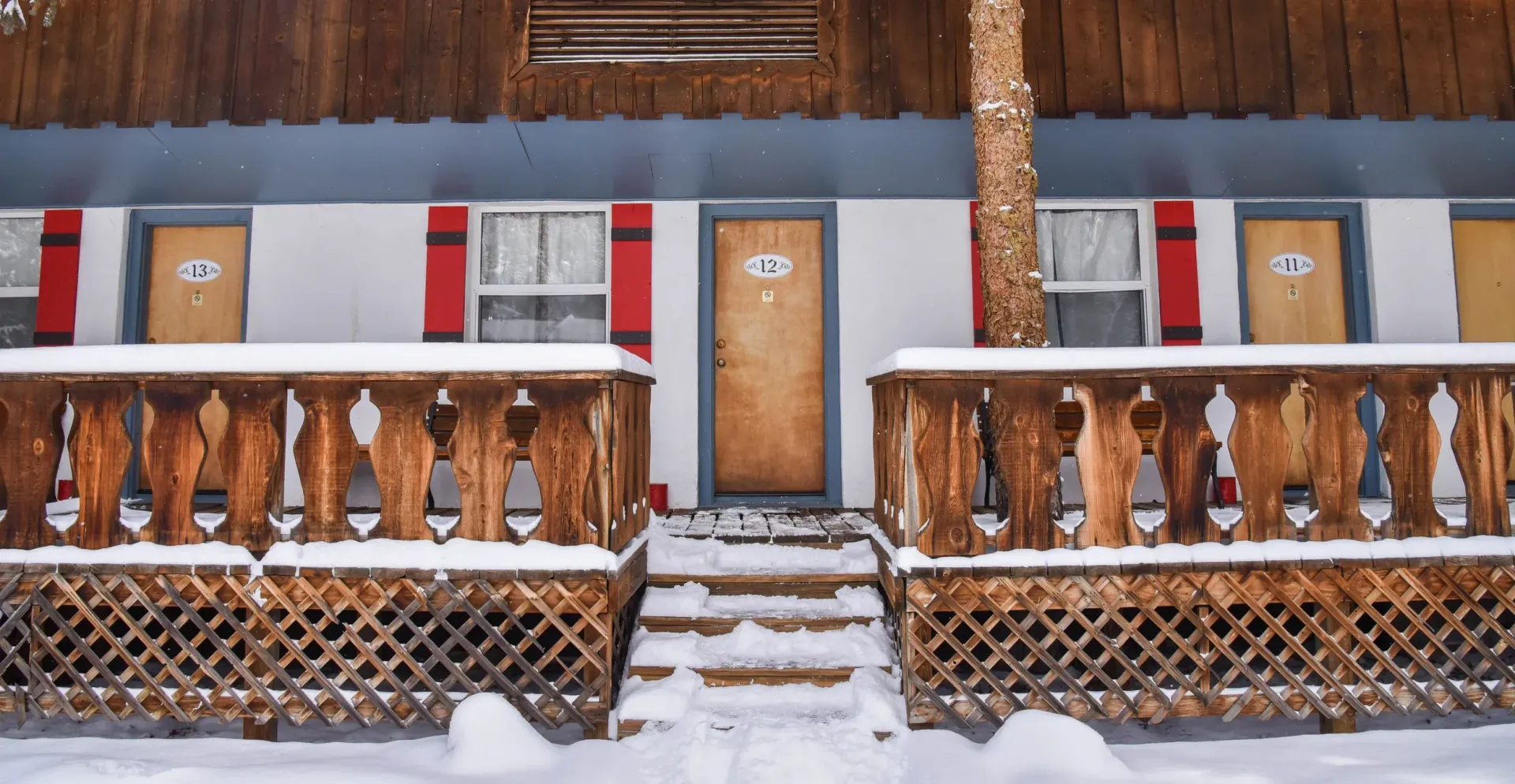 A house with a porch and stairs covered in snow
