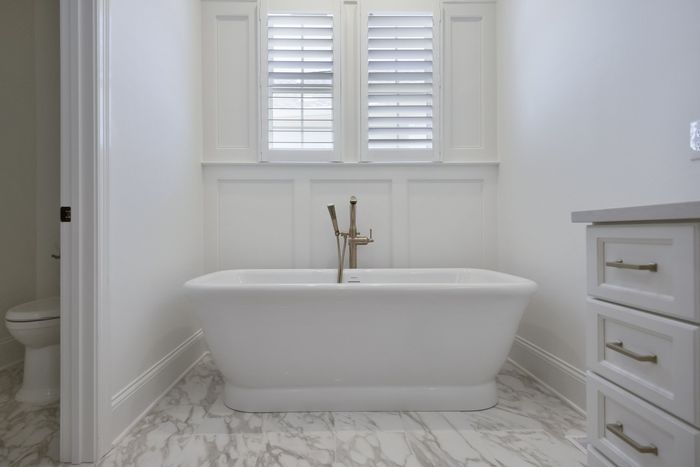 homearama 2020 custom home by joe kroll builder in Louisville Kentucky master bath freestanding porcelain tub