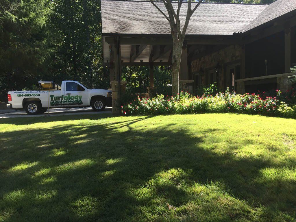 A white truck is parked in front of a house