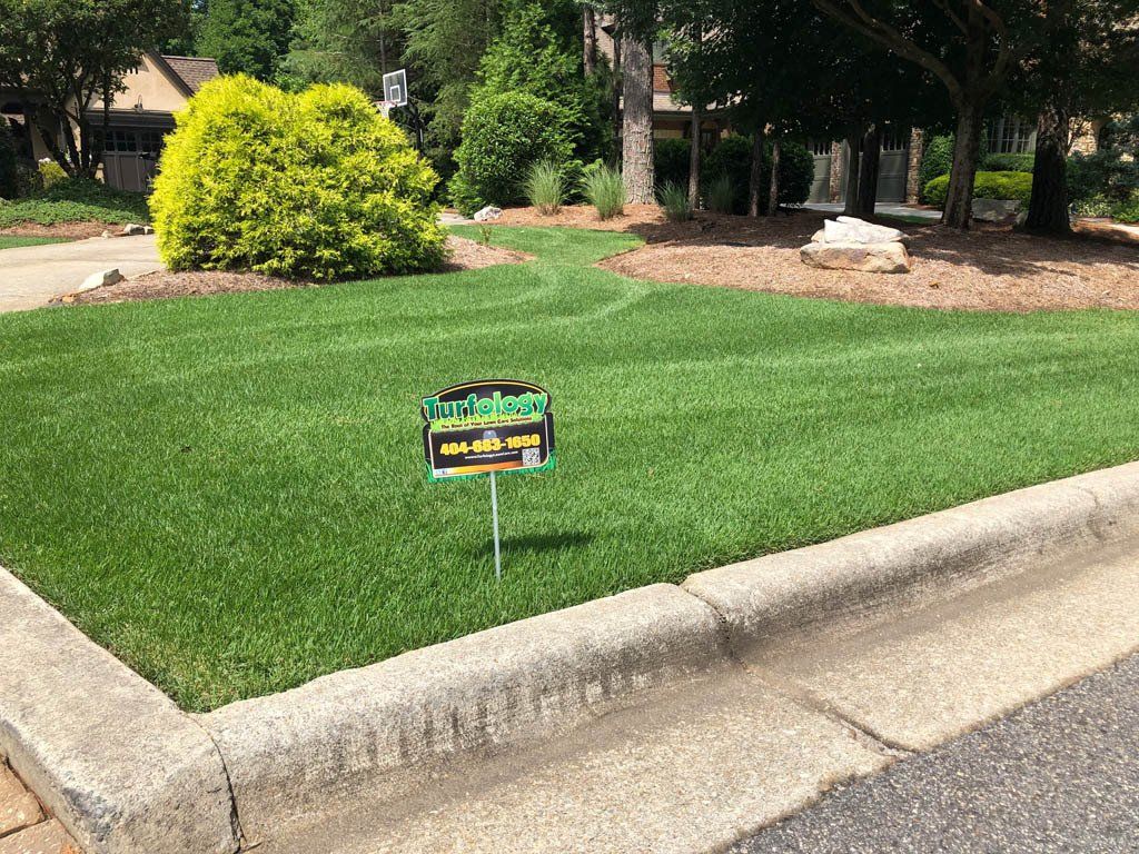A lawn with a sign in the middle of it.