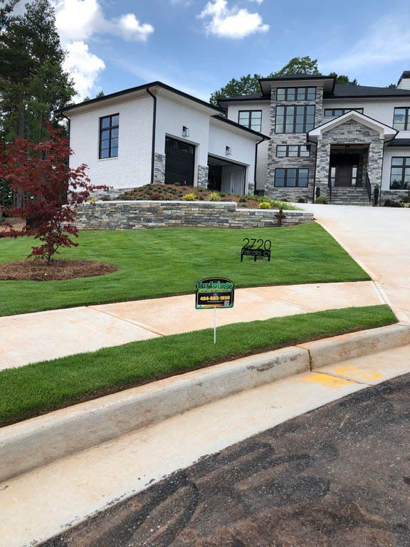 A large white house with a large lawn in front of it