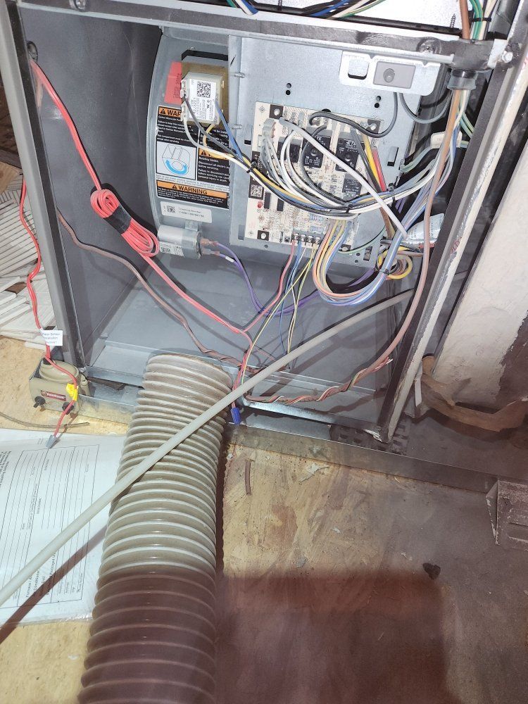 The inside of an air conditioner with a hose coming out of it.