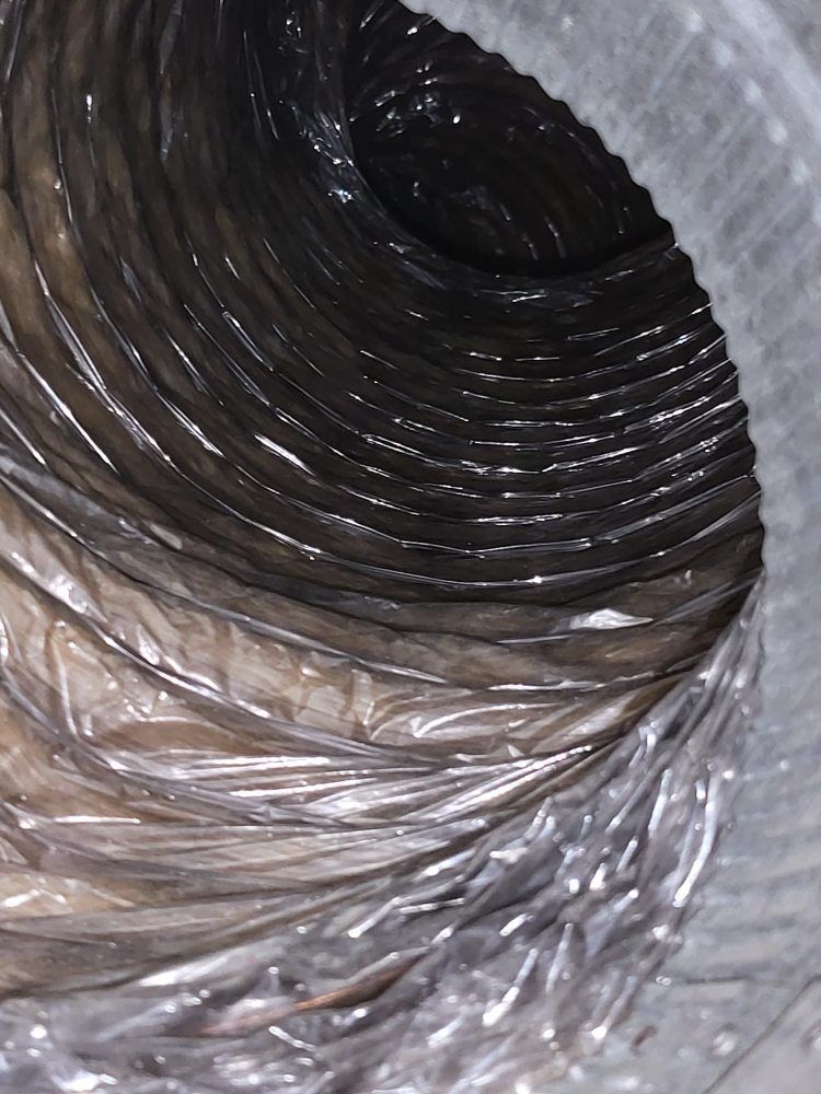 A close up of a plastic hose with a hole in it