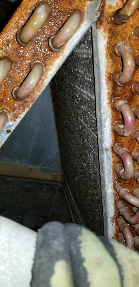 A close up of a rusty air conditioner coil.
