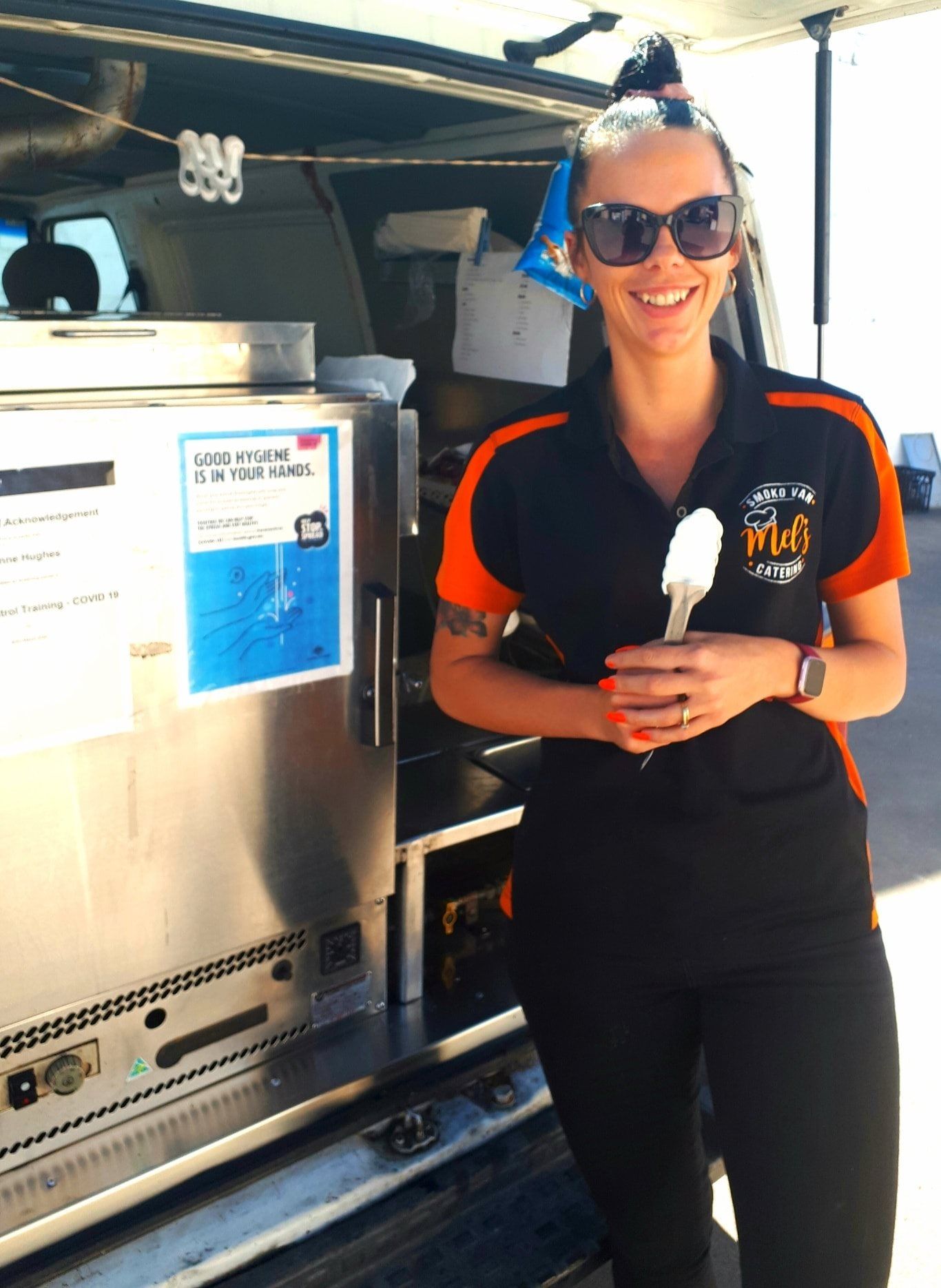 Woman in Uniform Holding Ice Cream Cone Smiling in Front of a Van — Mels Catering in Longreach, QLD