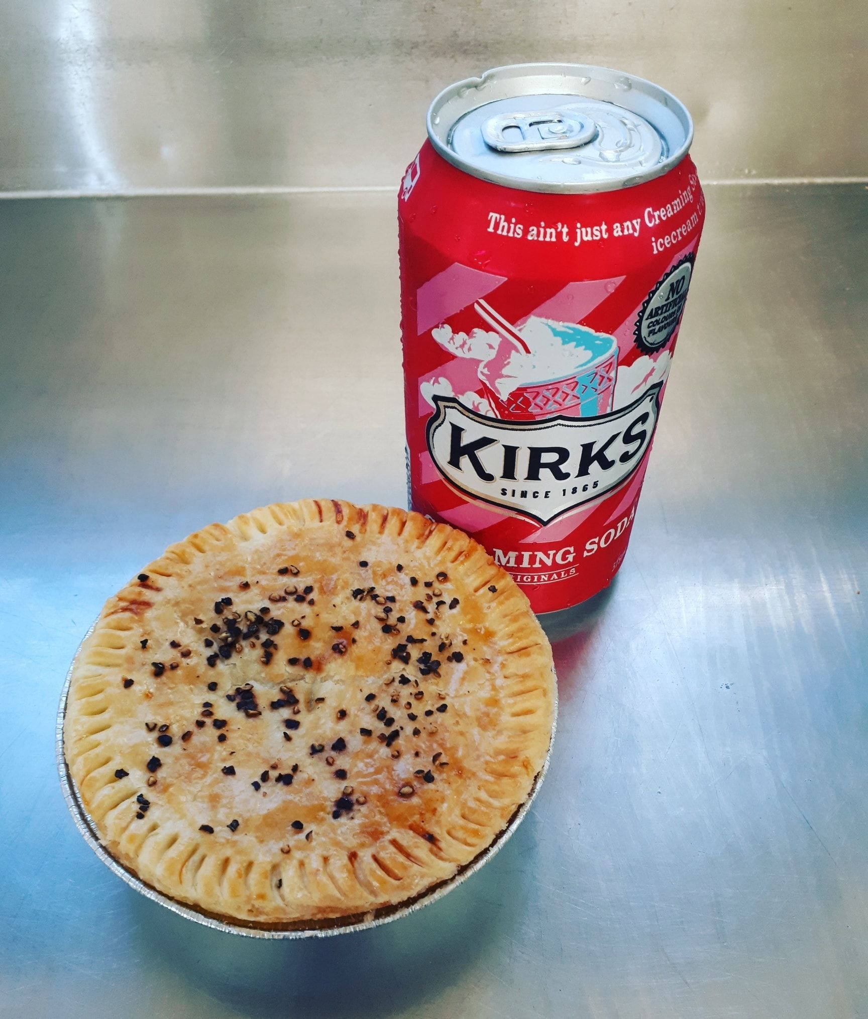 Pie With Kirks Creaming Soda Can On Stainless Steel Surface — Mels Catering in Garbutt, QLD