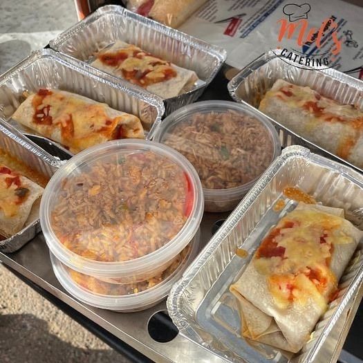 Aluminum containers with burritos and sides of rice; catering.— Mels Catering in Garbutt, QLD