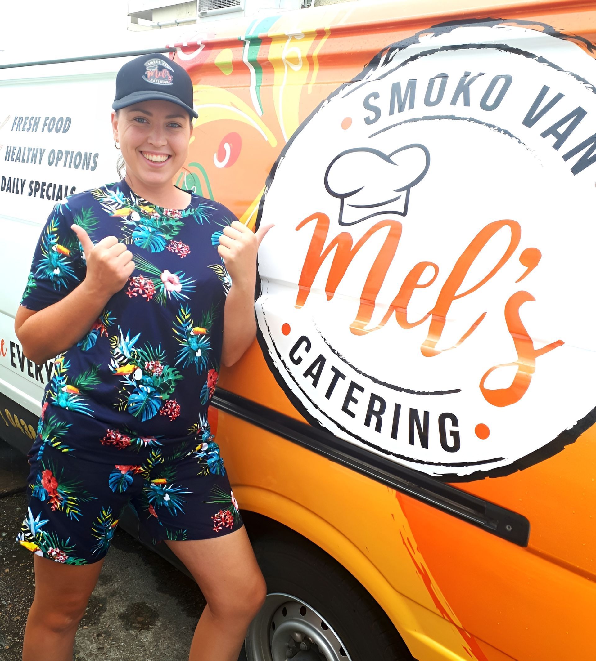 Woman in Floral Outfit Gives Thumbs Up Next to Food Truck — Mels Catering in Clermont, QLD