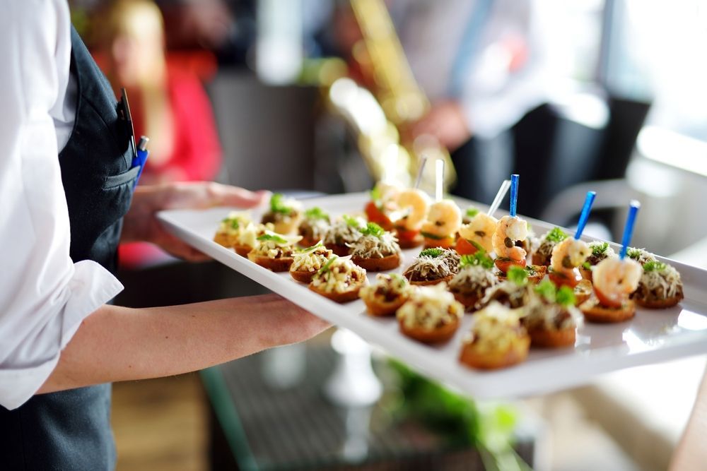 Waiter Carrying a Tray of Appetizers With Toothpicks — Mels Catering in Garbutt, QLD