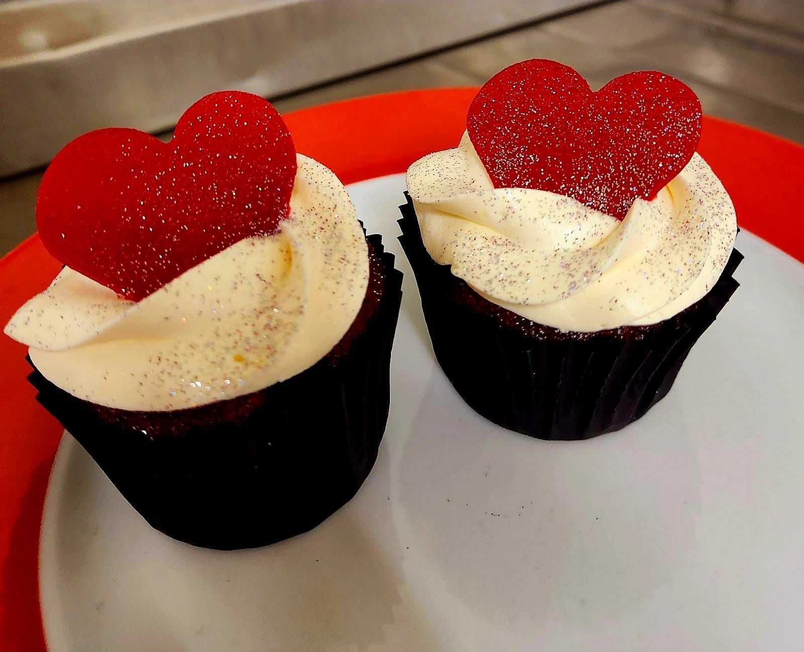 Two Red Velvet Cupcakes Topped With White Frosting — Mels Catering in Julia Creek, QLD