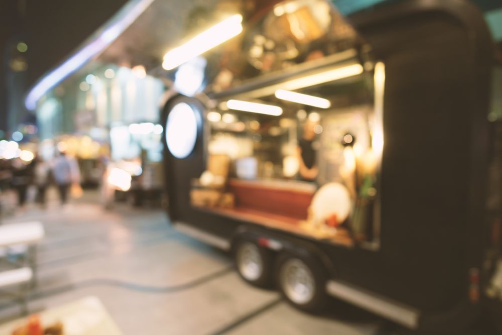 Food Truck at an Outdoor Event Serving Visitors in a Busy Night — Mels Catering in Garbutt, QLD
