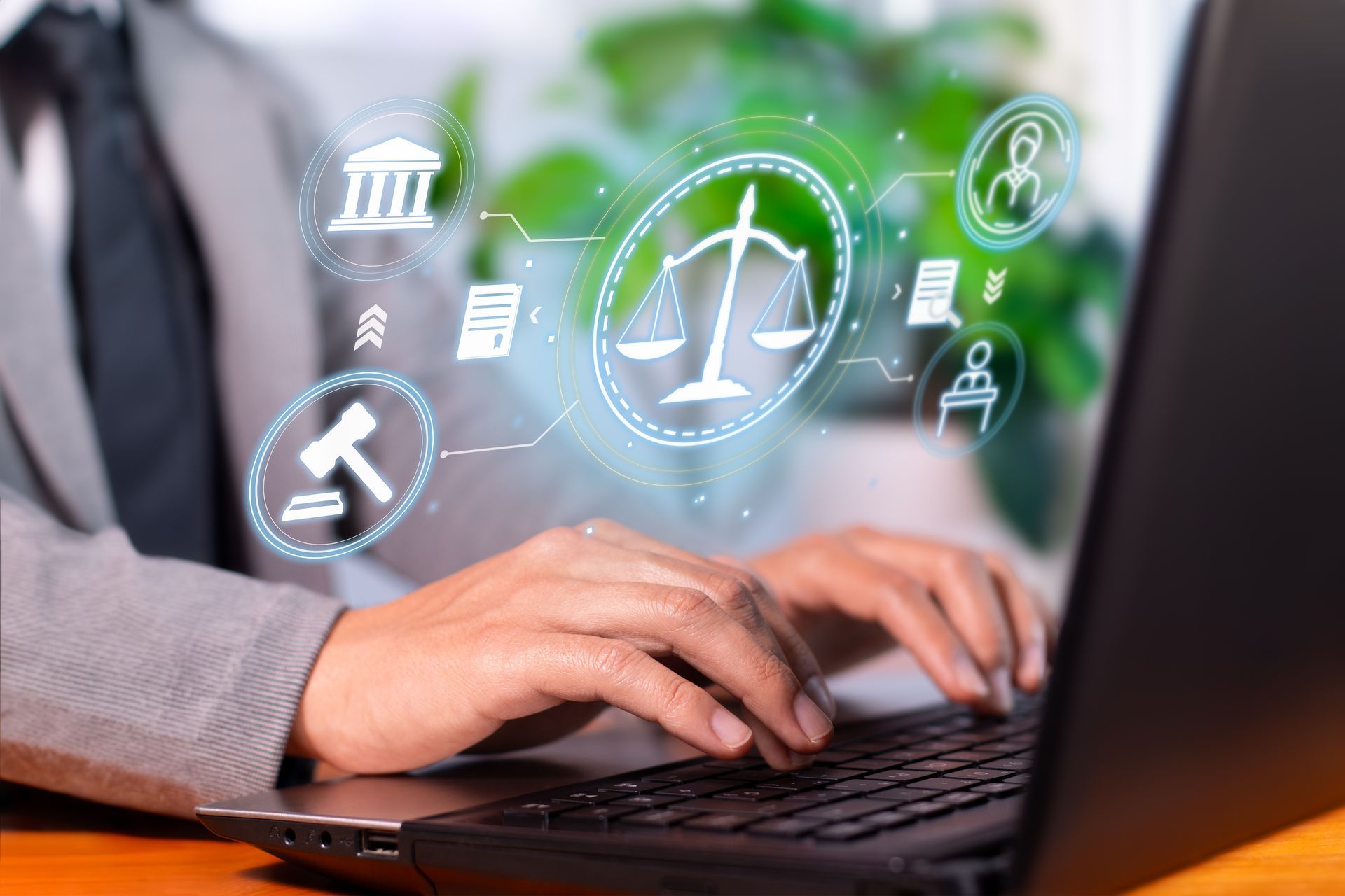 Person typing on laptop, overlaid with digital legal icons: gavel, scales, documents.