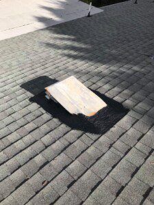 A wooden ramp is sitting on top of a brick roof.