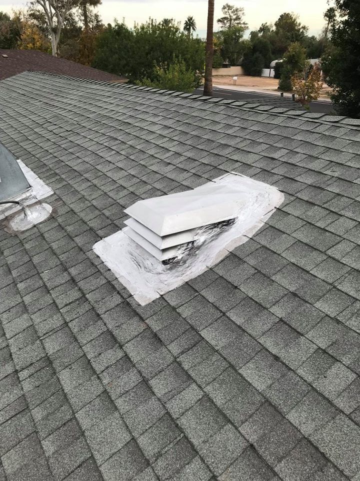 A roof with a skylight and a vent on it.