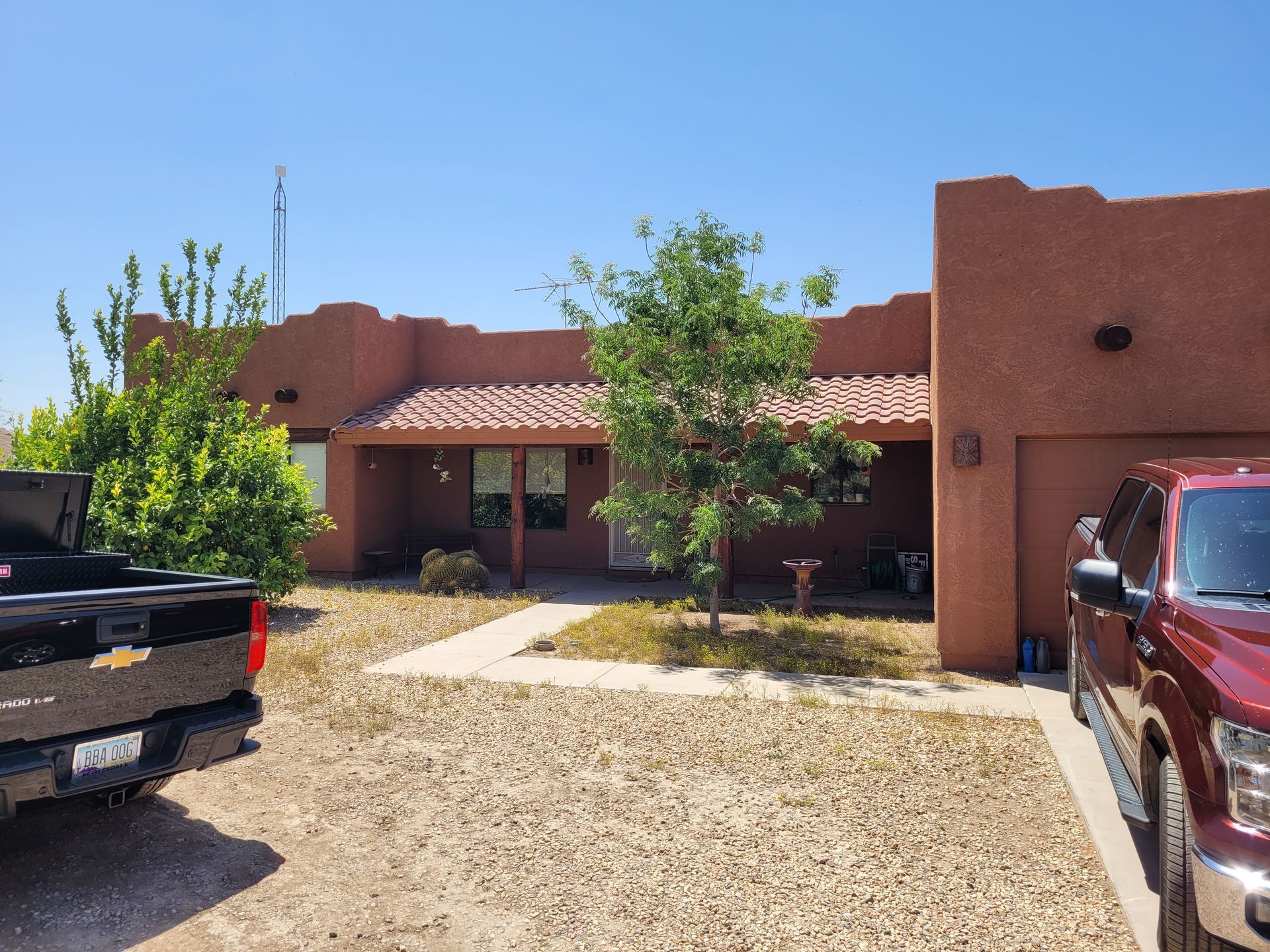 A large house with a concrete driveway in front of it