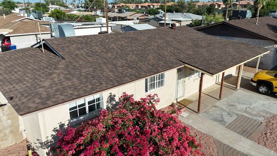 An aerial view of a house with a car parked in front of it.