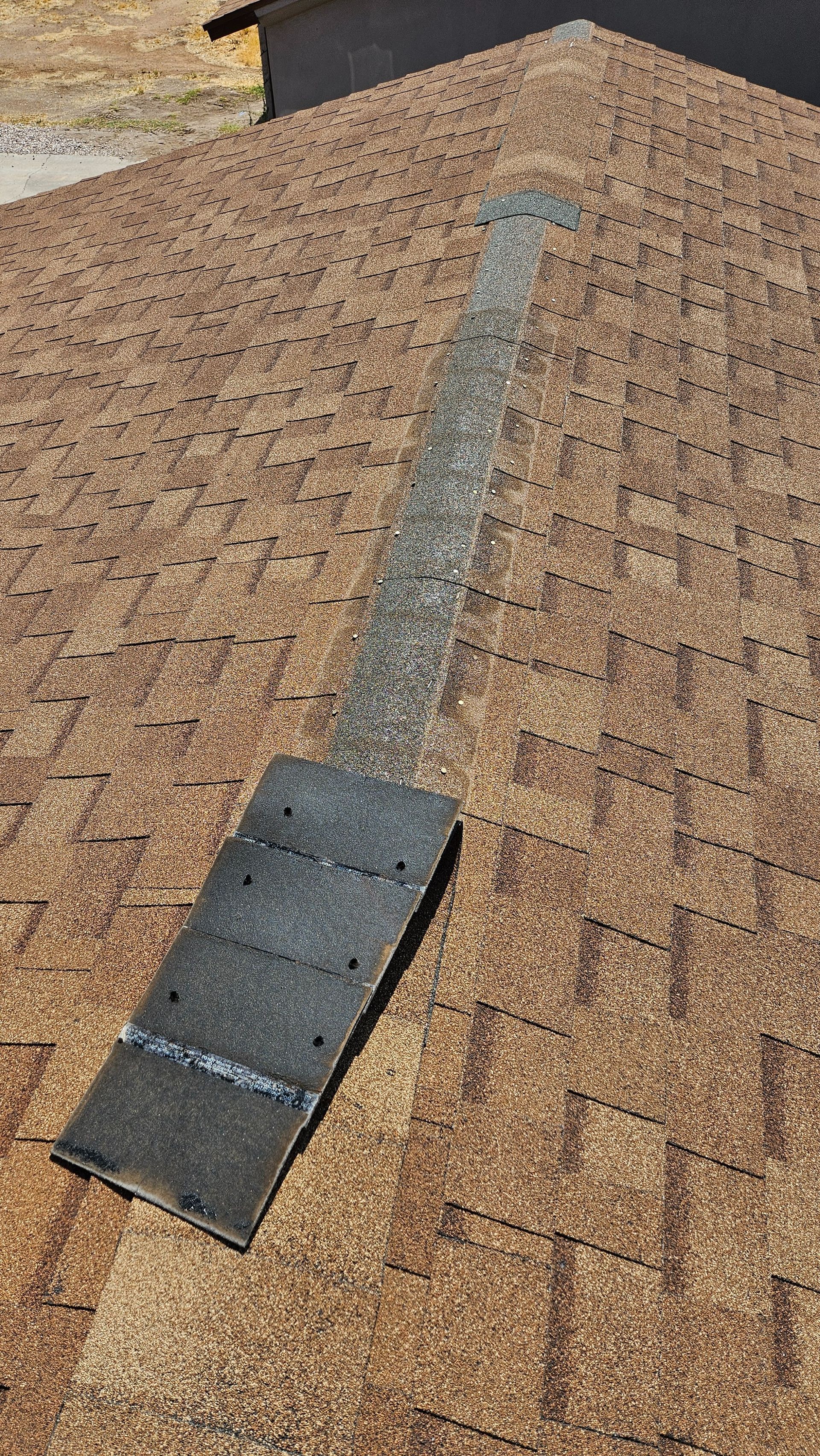 A roof with a lot of shingles and a hole in it.