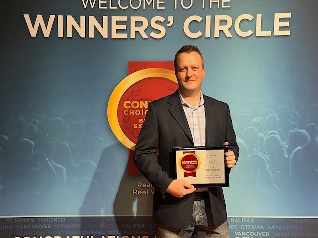 A concrete walkway leading to the front door of a house.