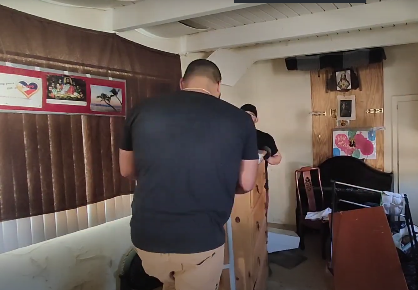 2 haulers loading old furniture on wheelie trolley