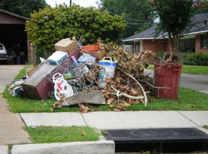 Yard waste including soil and branches and dead leaves with unused appliances left for hauling