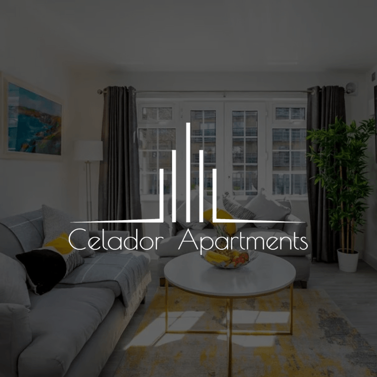 A living room with a couch and a table and the logo for celador apartments