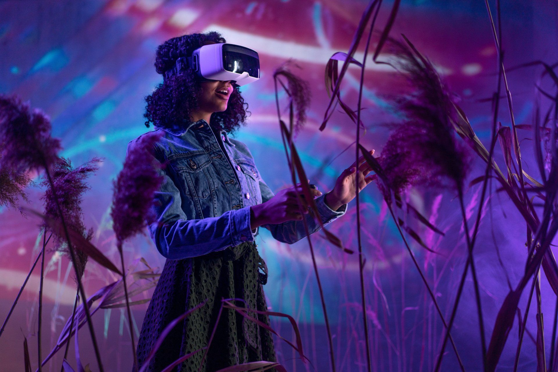 Woman in a VR headset walking through virtual tall grass