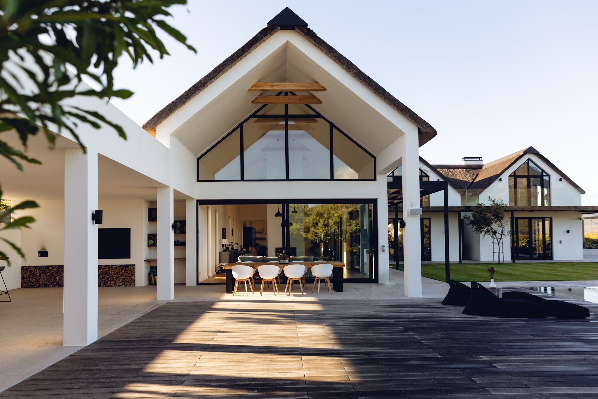 A large white house with a wooden deck in front of it.