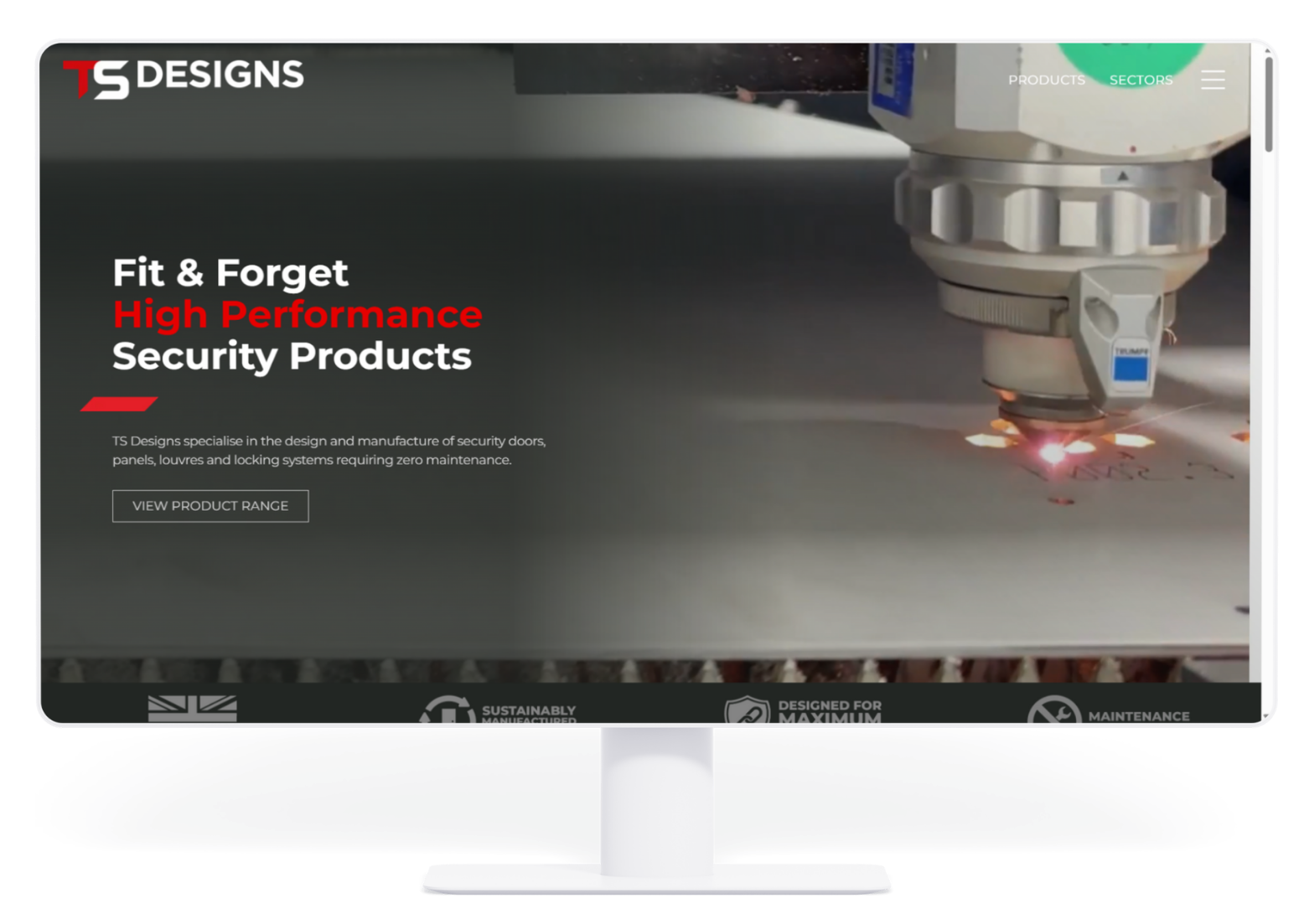 Computer monitor displaying the S Designs website homepage, featuring industrial laser cutting and security product text.