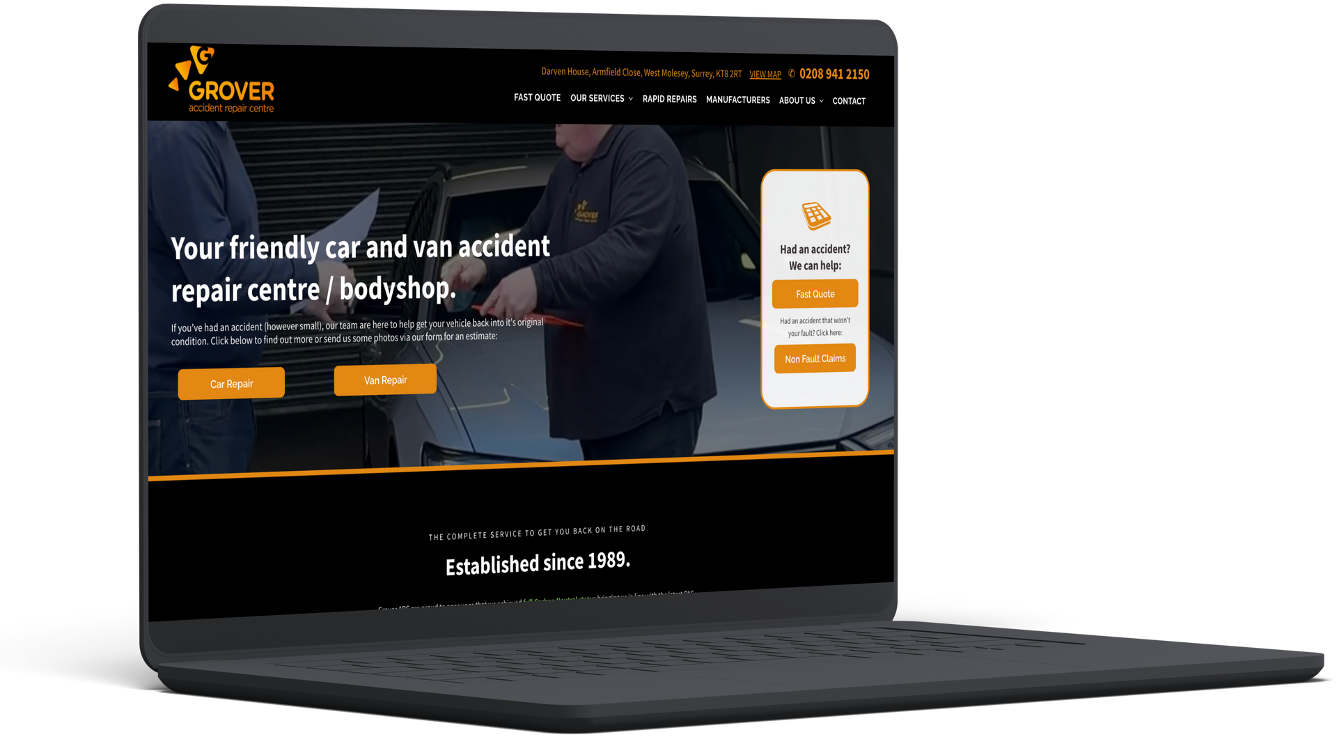Laptop displaying the website of a car and van accident repair center. Website features text and an image of a repair.