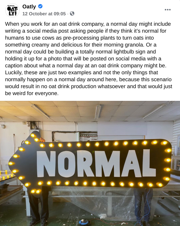 A person is holding a sign that says normal on it.