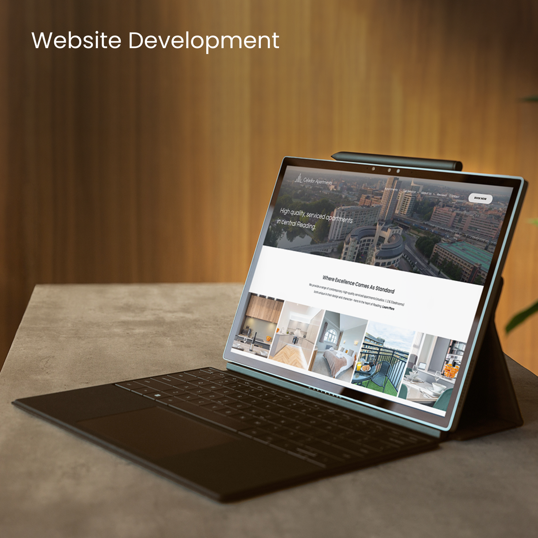 A laptop showing a website mockup of a serviced apartments company