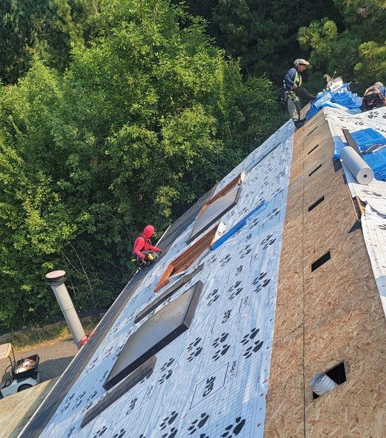 A group of people are working on a roof.